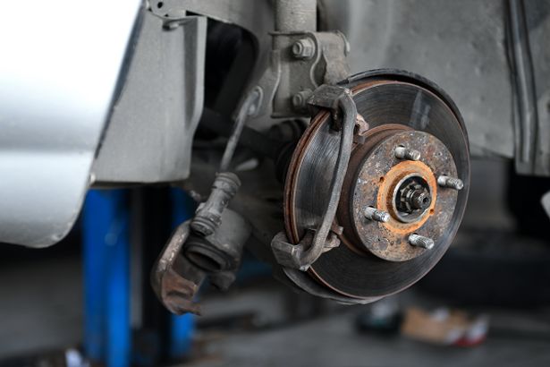 Car without wheels showing brake disc and rotors
